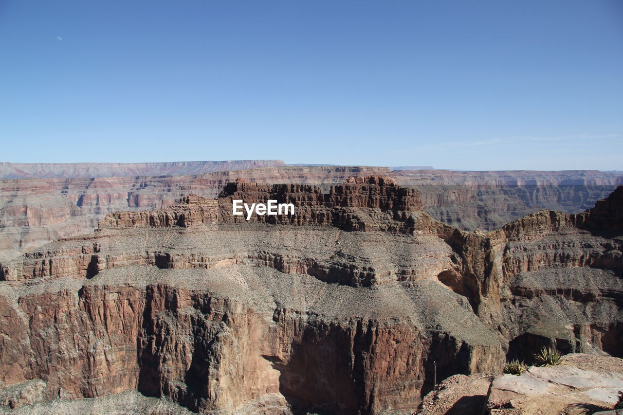 Scenic view of rocky mountains against clear blue sky at grand canyon national park