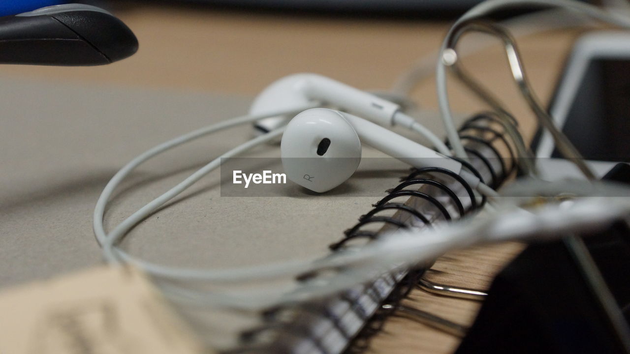 Close-up of headphones on diary
