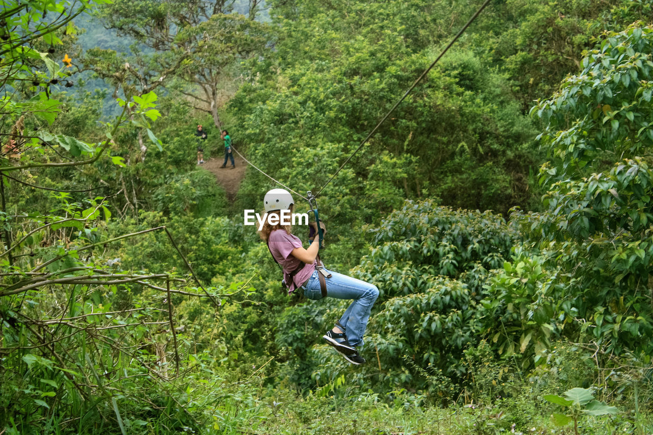 MAN STANDING IN FOREST