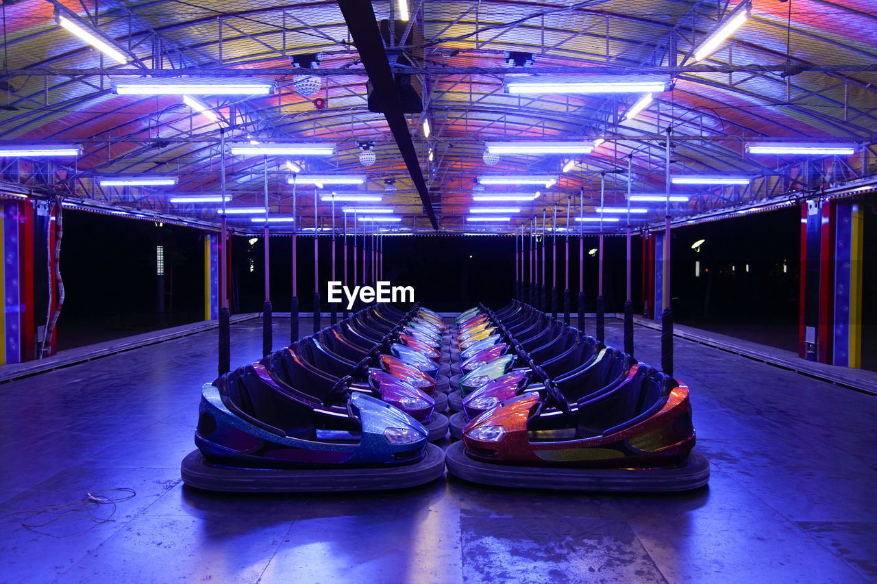 Row of empty bumper cars at amusement park