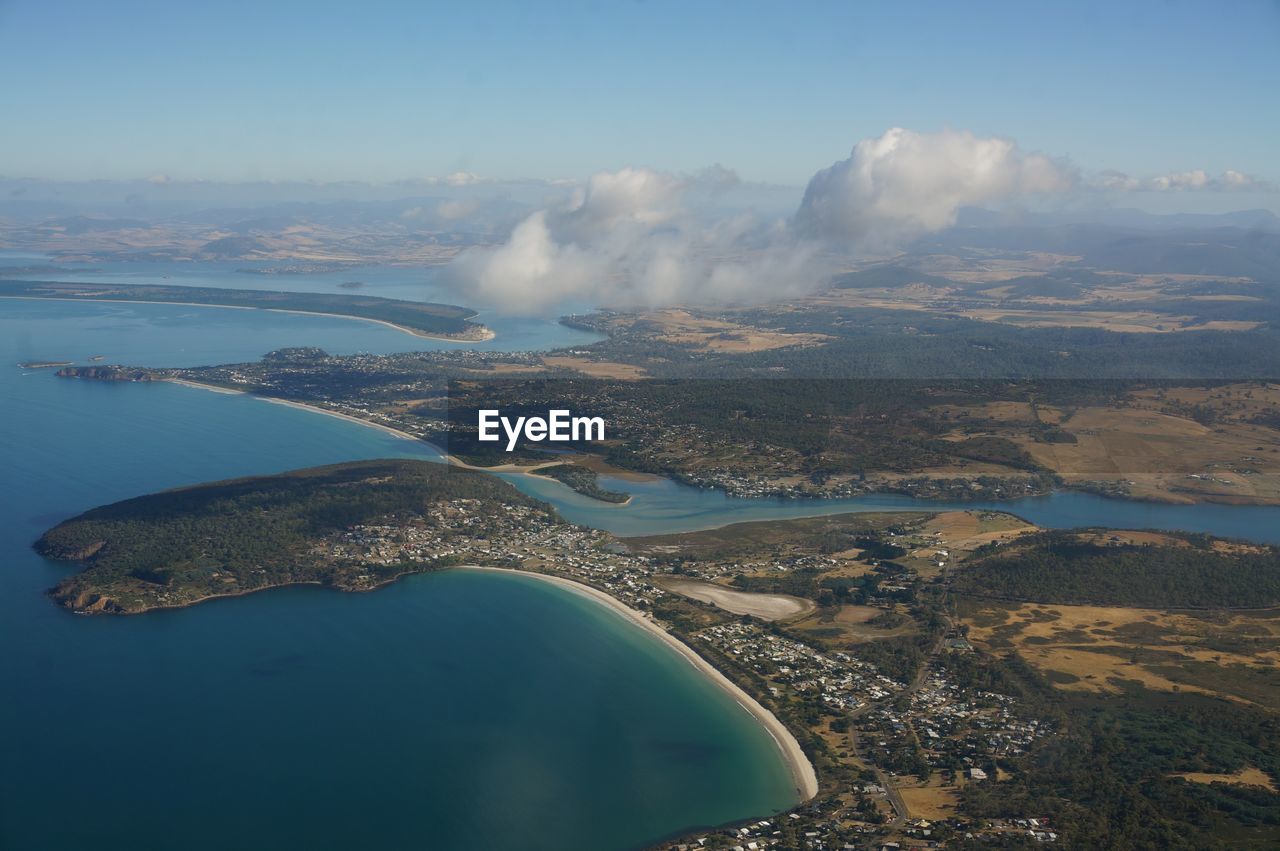 Aerial view of landscape and sea against sky