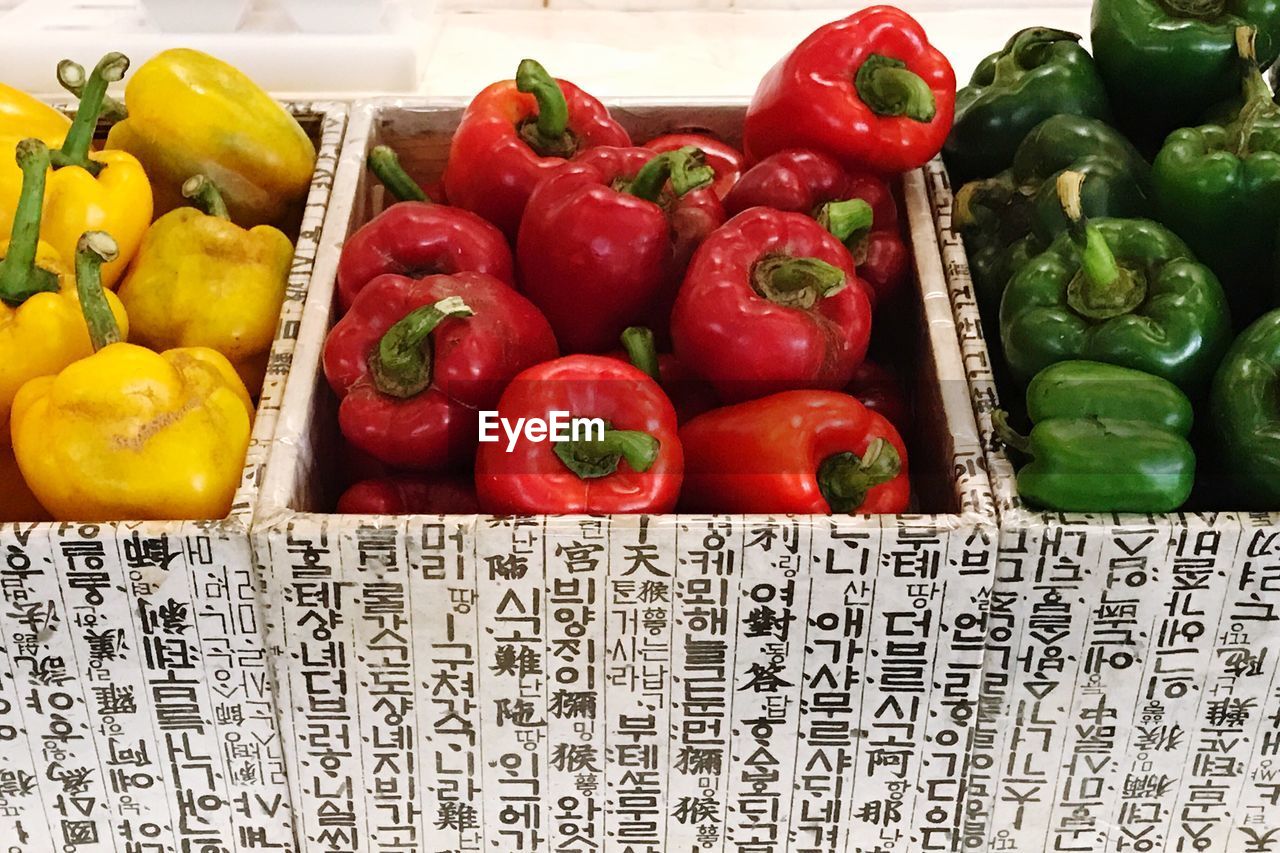 CLOSE-UP OF RED BELL PEPPERS IN CONTAINER