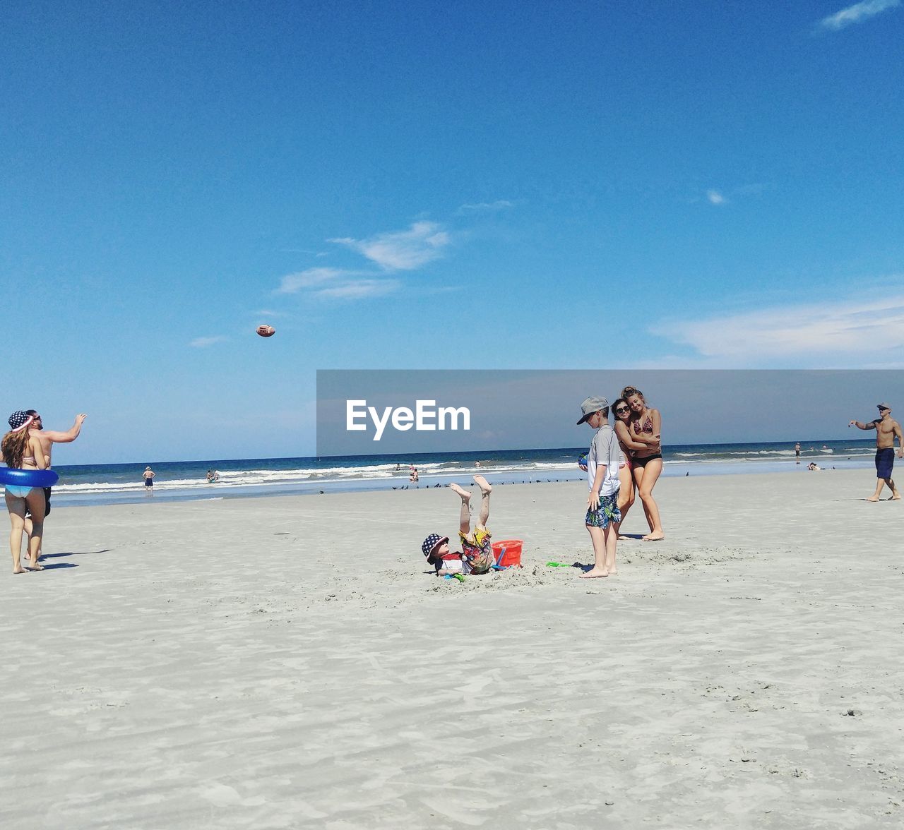 People at beach on sunny day