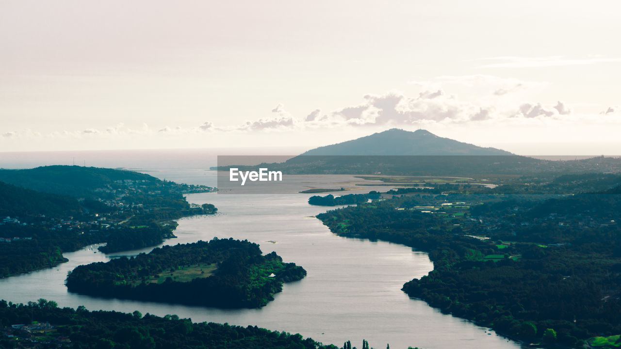 Scenic view of river, sea and mountains against sky