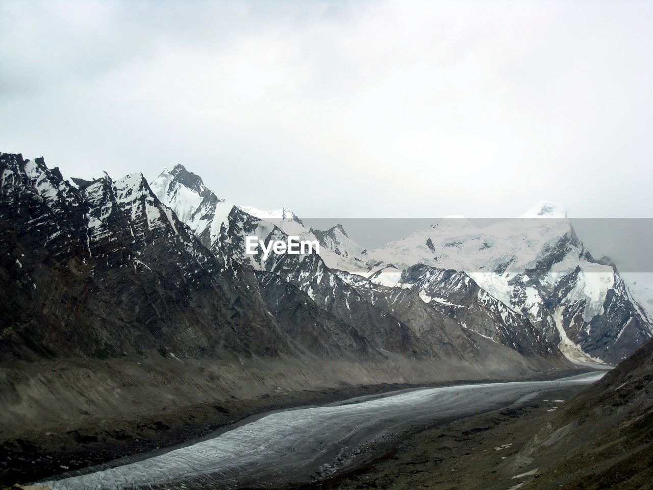 Scenic view of mountains against cloudy sky