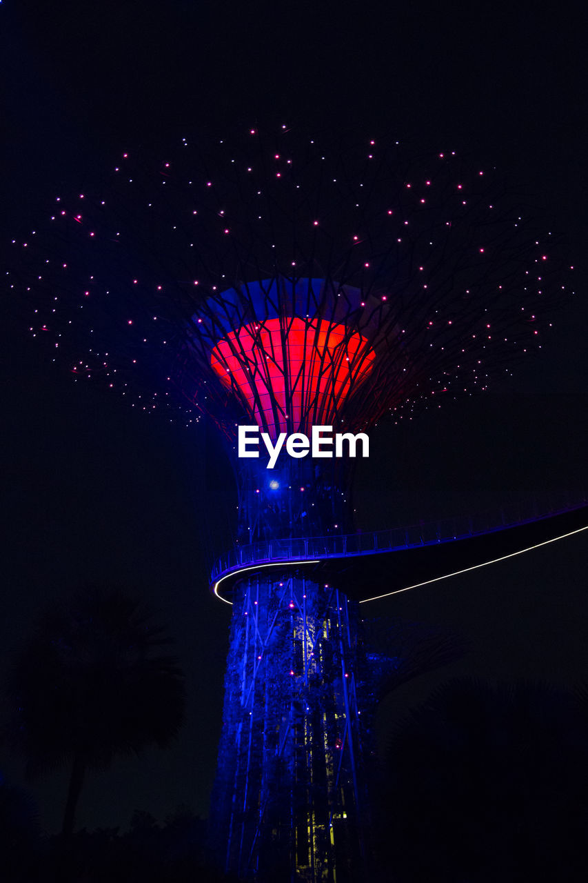 LOW ANGLE VIEW OF ILLUMINATED FIREWORKS AGAINST SKY