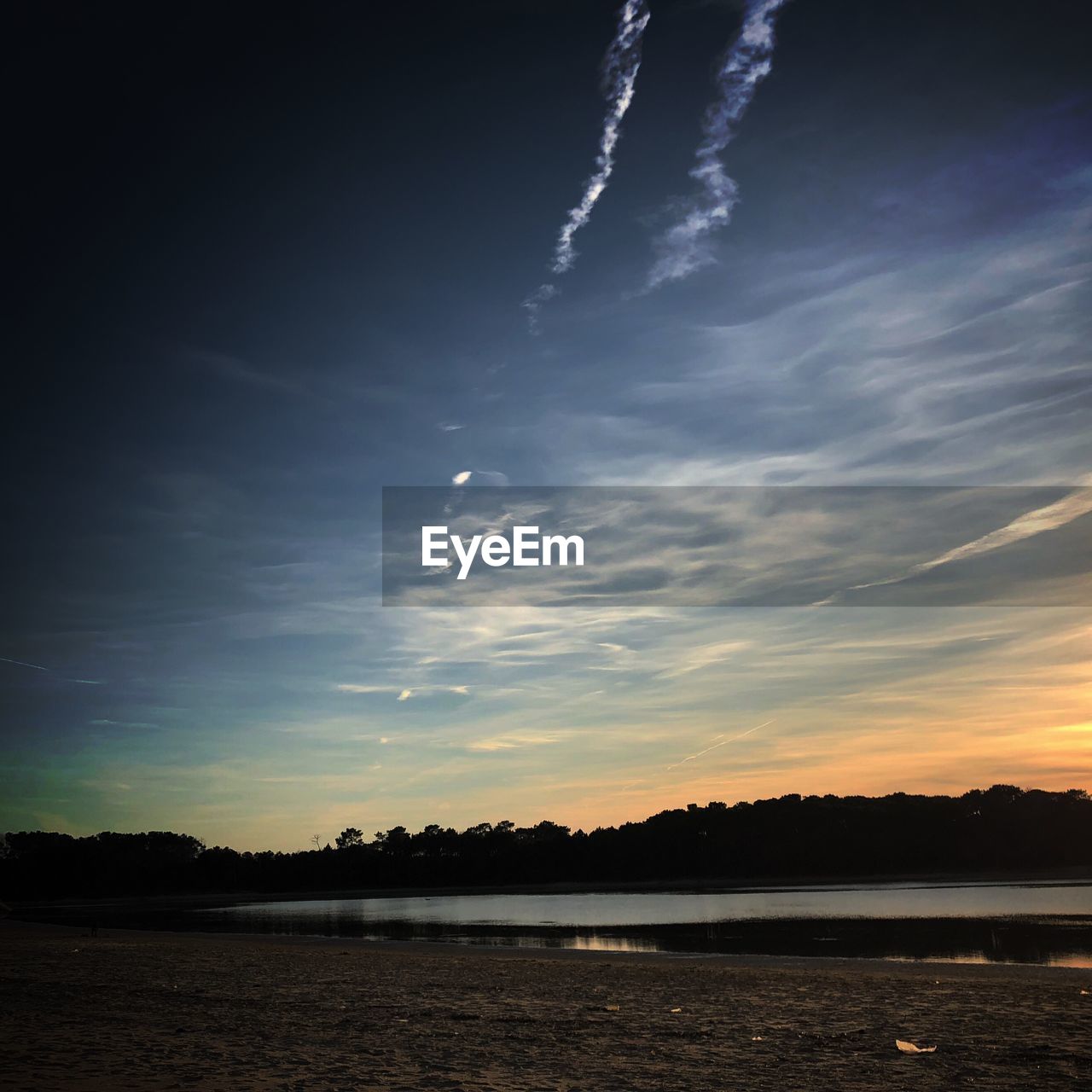 SCENIC VIEW OF SILHOUETTE LAND AGAINST SKY AT SUNSET