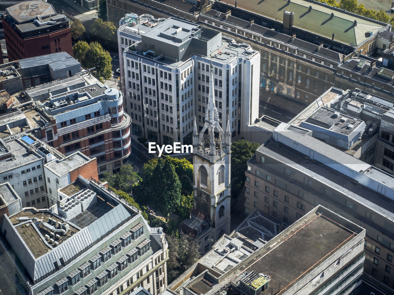 High angle view of old church between modern buildings in london