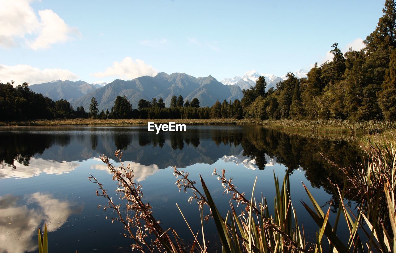 Scenic view of lake and mountains against sky