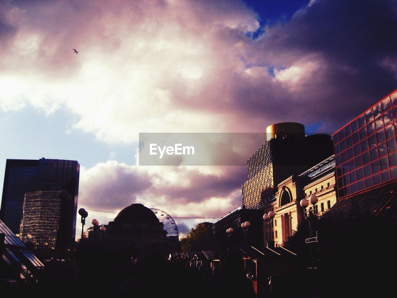 Modern cityscape under dramatic sky