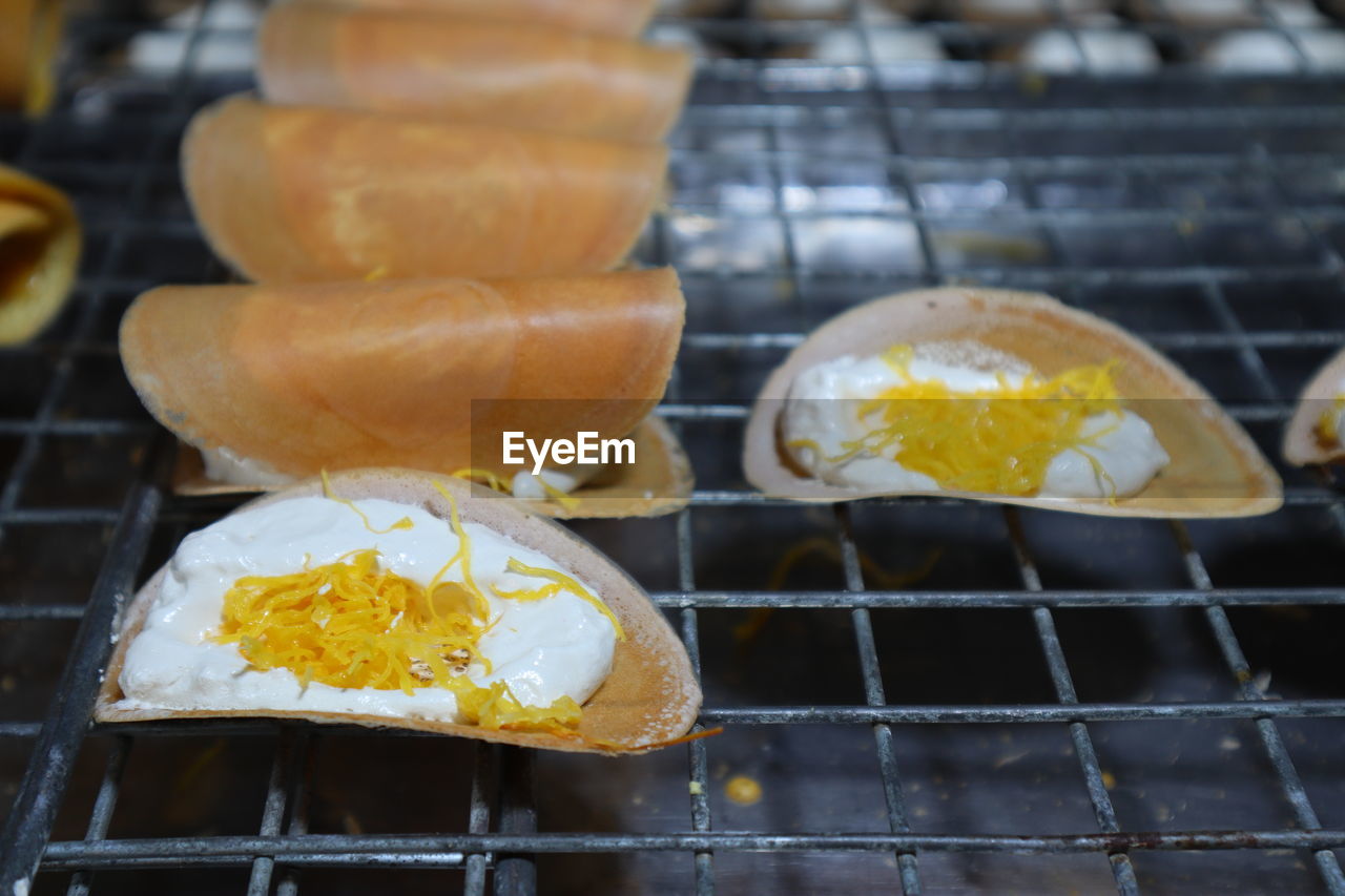 Close-up of yellow food on metal grate