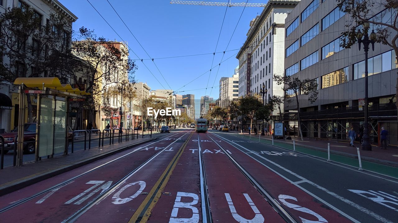 View of city buildings against blue sky