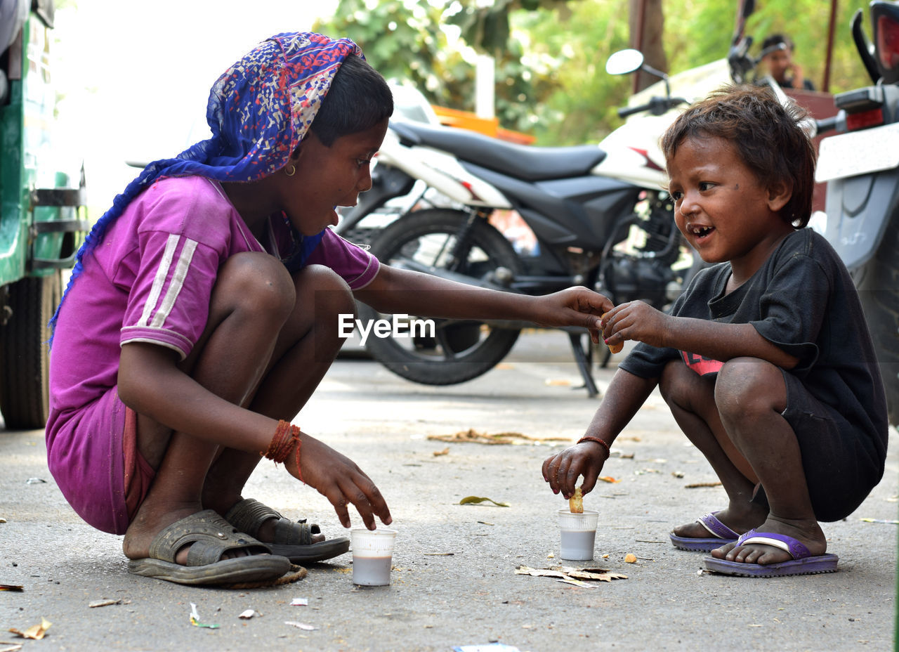 Beggar with brother on street