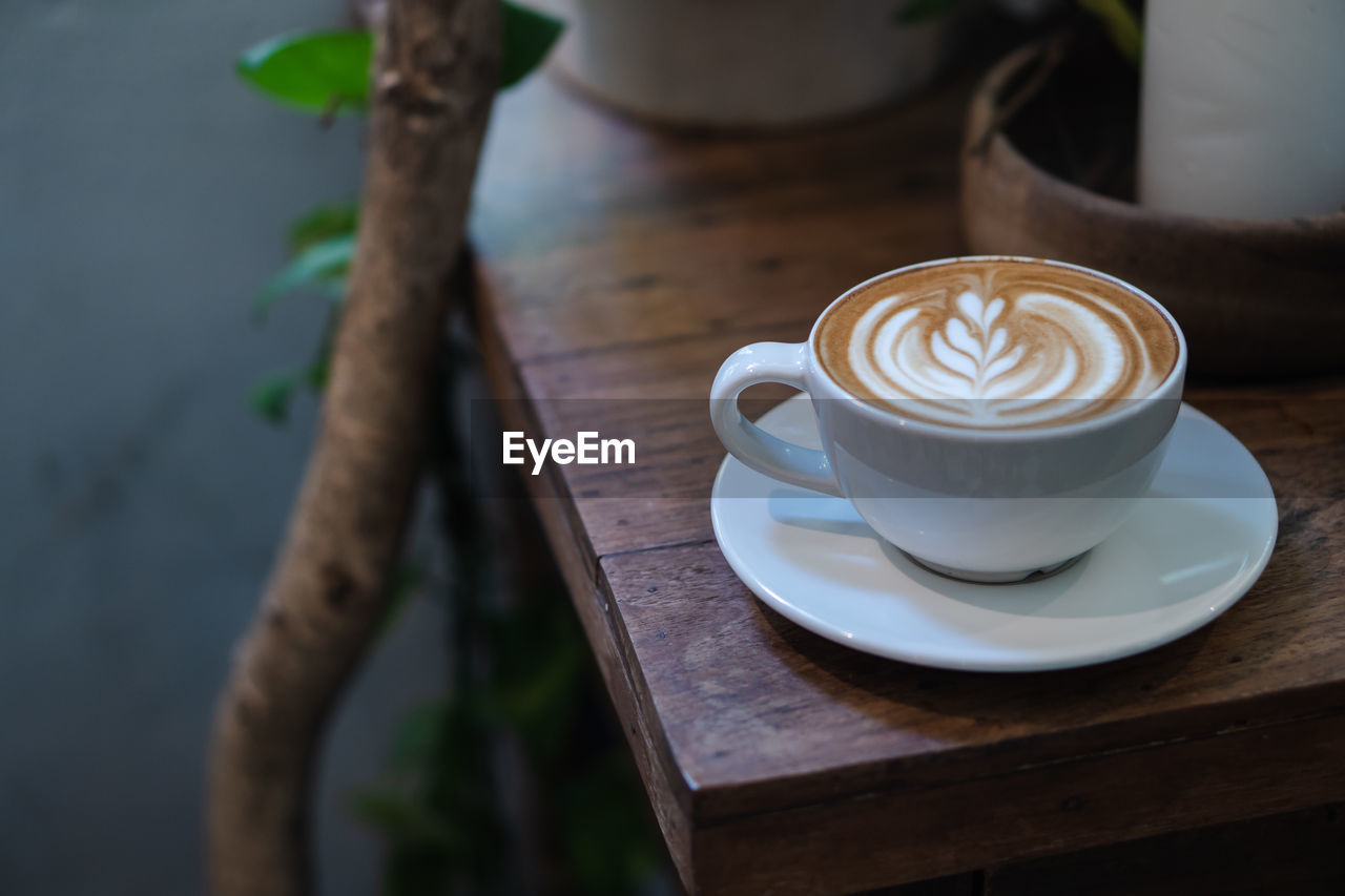 HIGH ANGLE VIEW OF COFFEE CUP WITH SPOON ON TABLE