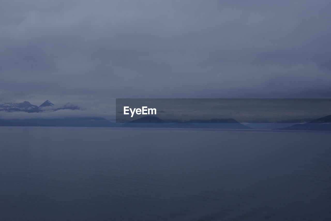 SCENIC VIEW OF SEA AND MOUNTAIN AGAINST SKY