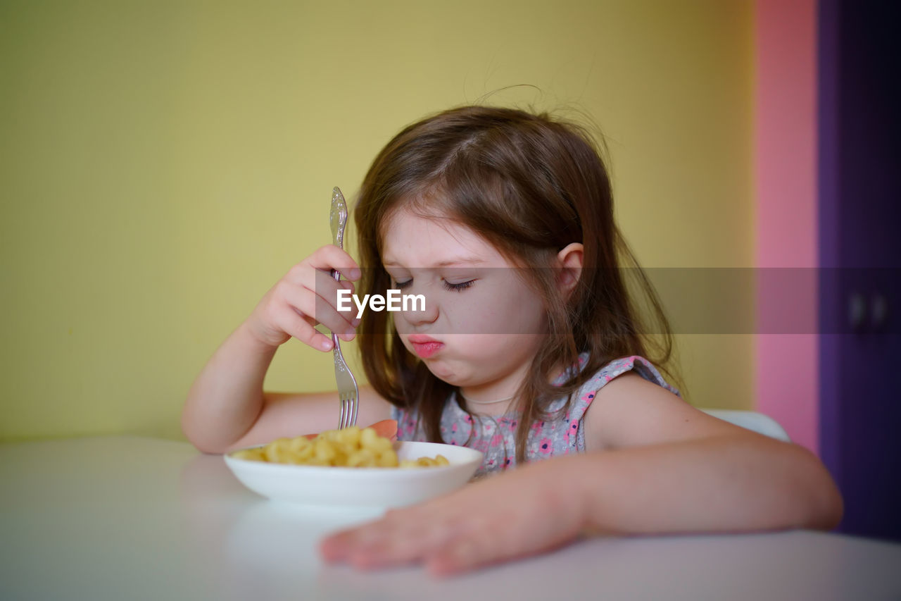 The little girl does not want to eat. selective focus, shallow depth of field