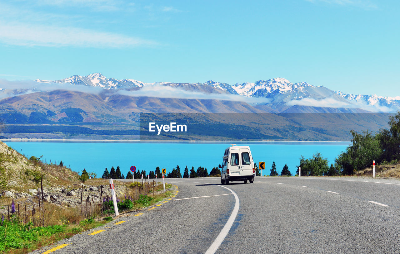 SCENIC VIEW OF ROAD AGAINST BLUE SKY