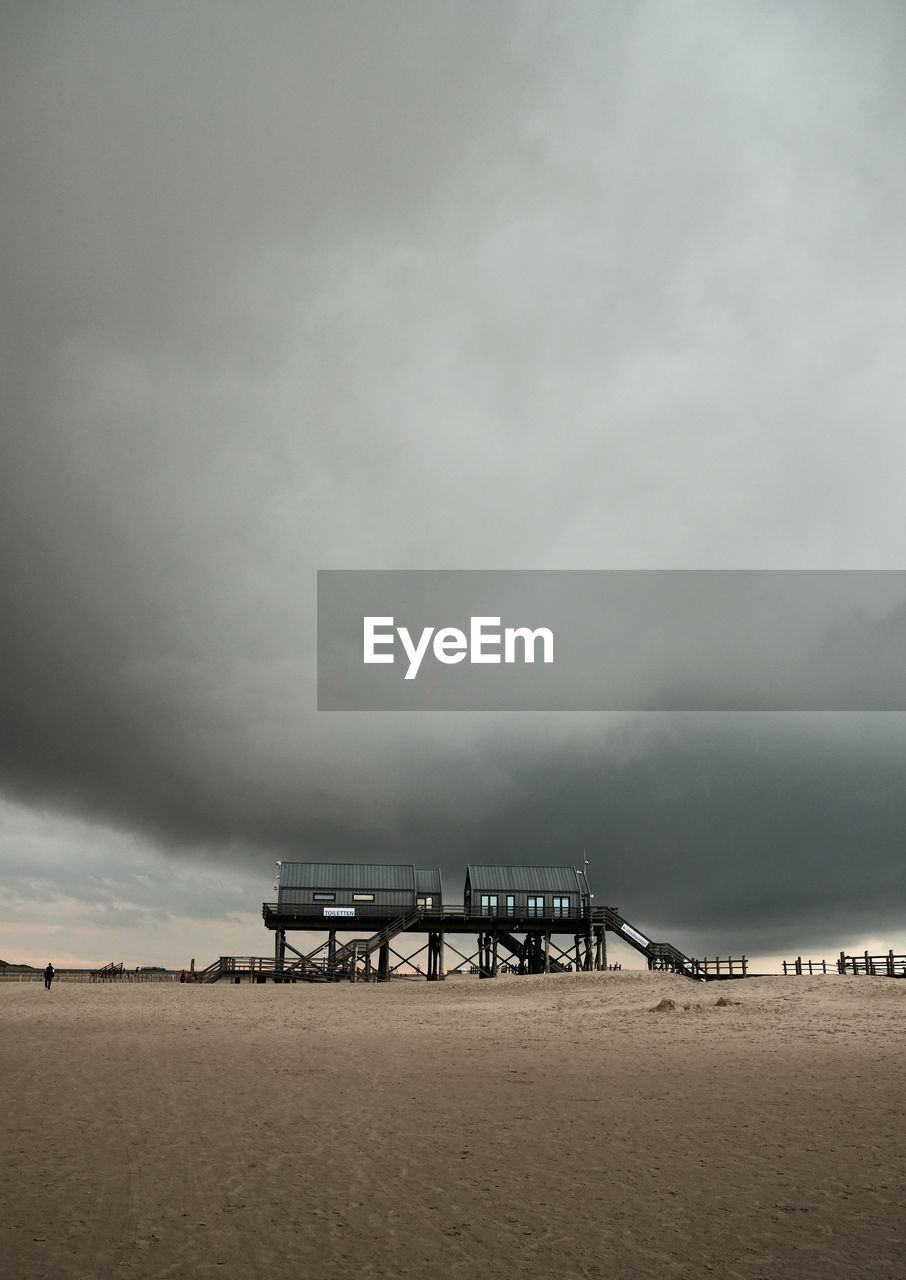 Lifeguard hut on a beach against cloudy sky