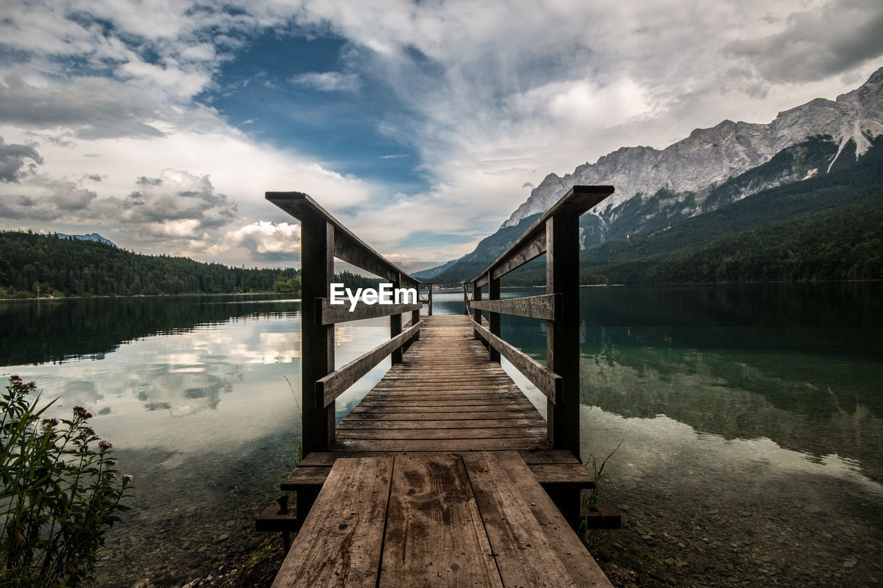 Pier on lake against sky