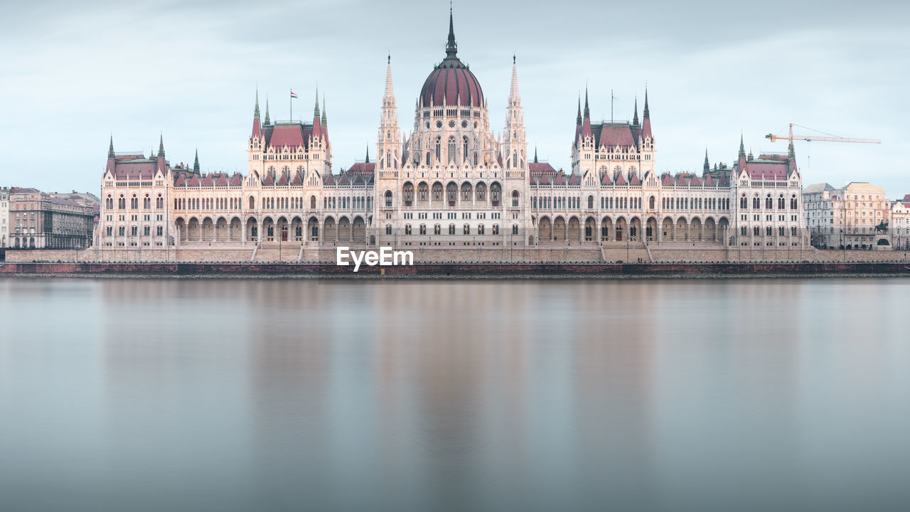 View of historic building by river in city