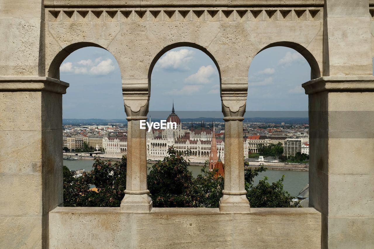 Hungarian parliament building seen through arch window