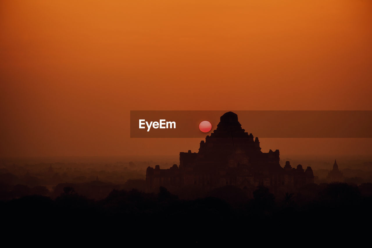 SILHOUETTE OF TEMPLE AT SUNSET