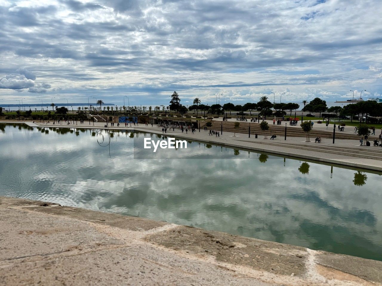water, shore, sea, sky, architecture, reflection, cloud, nature, coast, built structure, travel destinations, reservoir, body of water, travel, beach, environment, tourism, land, outdoors, horizon, landscape, scenics - nature, building exterior, day, city, beauty in nature, bay, building, bridge, ocean, walkway, tranquility, morning, vacation