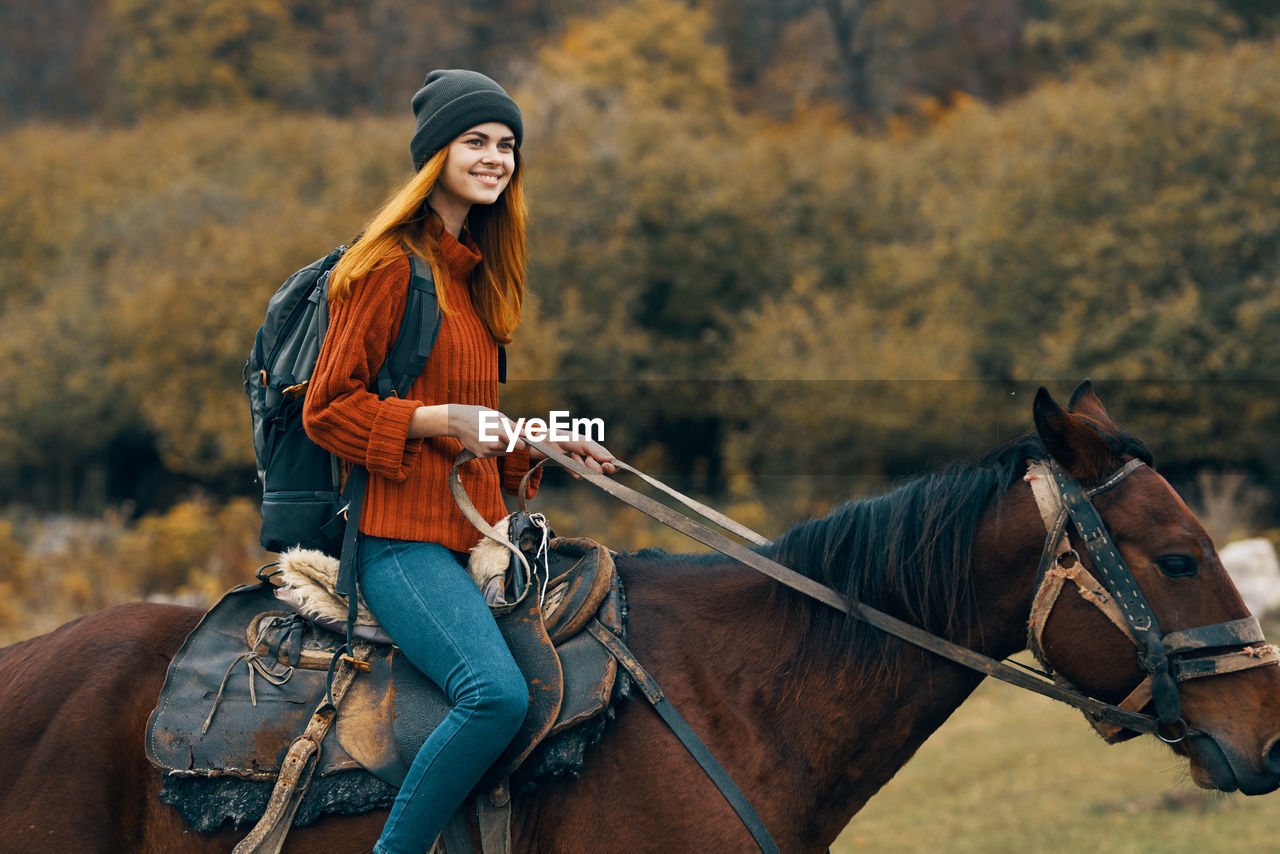 WOMAN RIDING HORSE