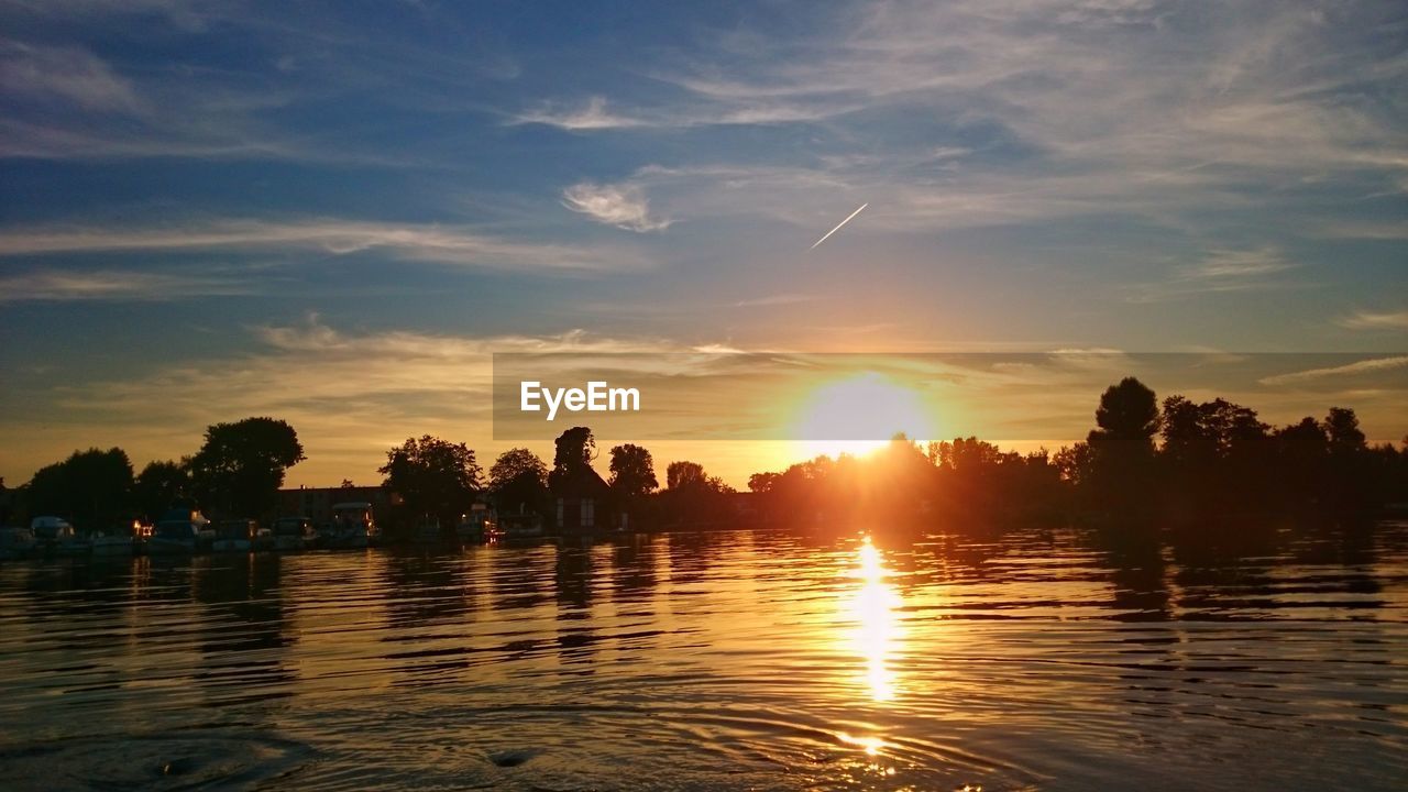 SCENIC VIEW OF SUNSET OVER WATER