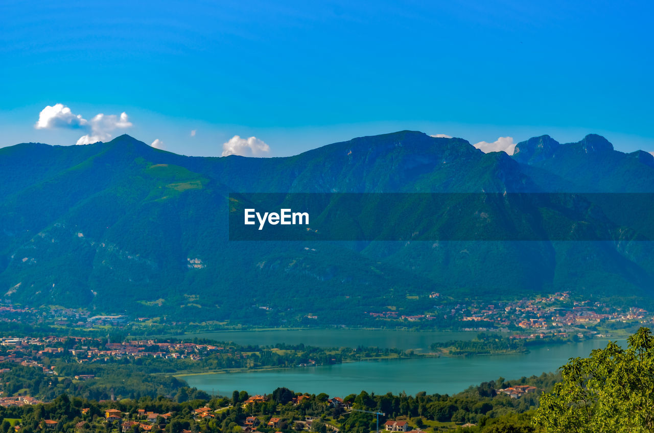 Scenic view of mountains against blue sky