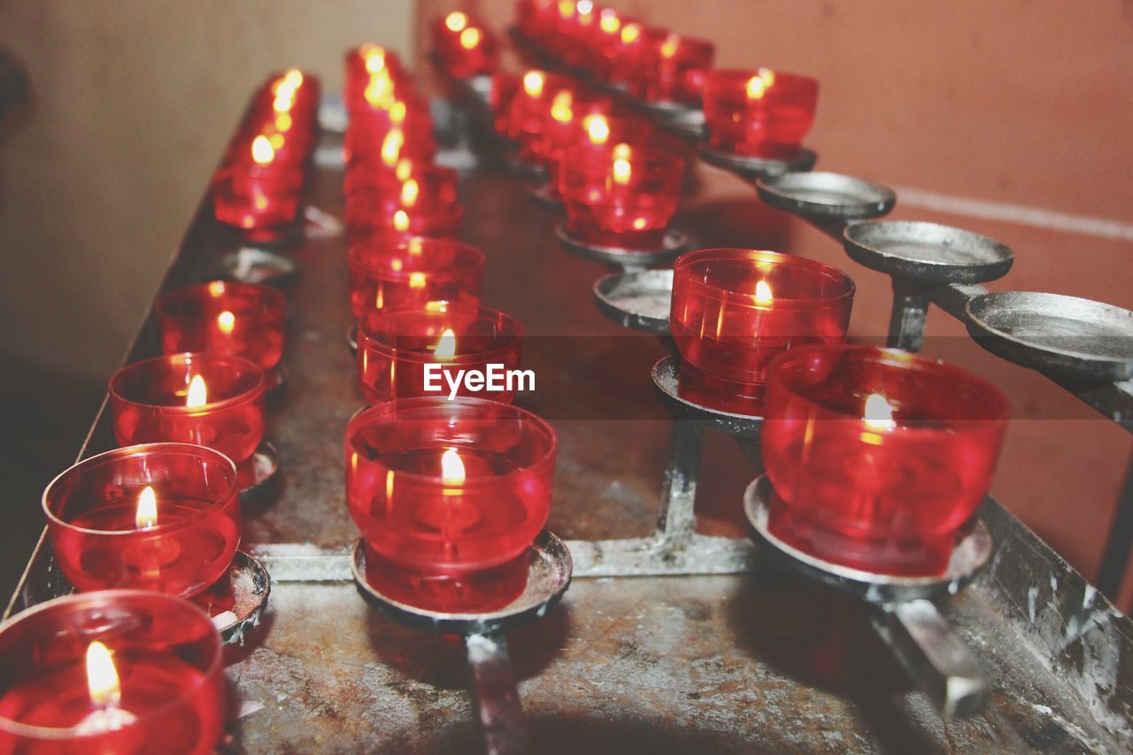 High angle view of illuminated candles on table