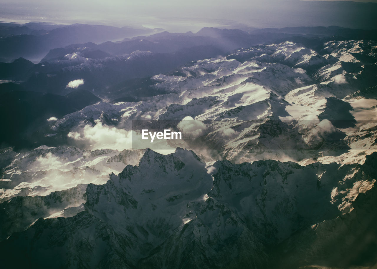 Scenic view of snow covered mountains against sky