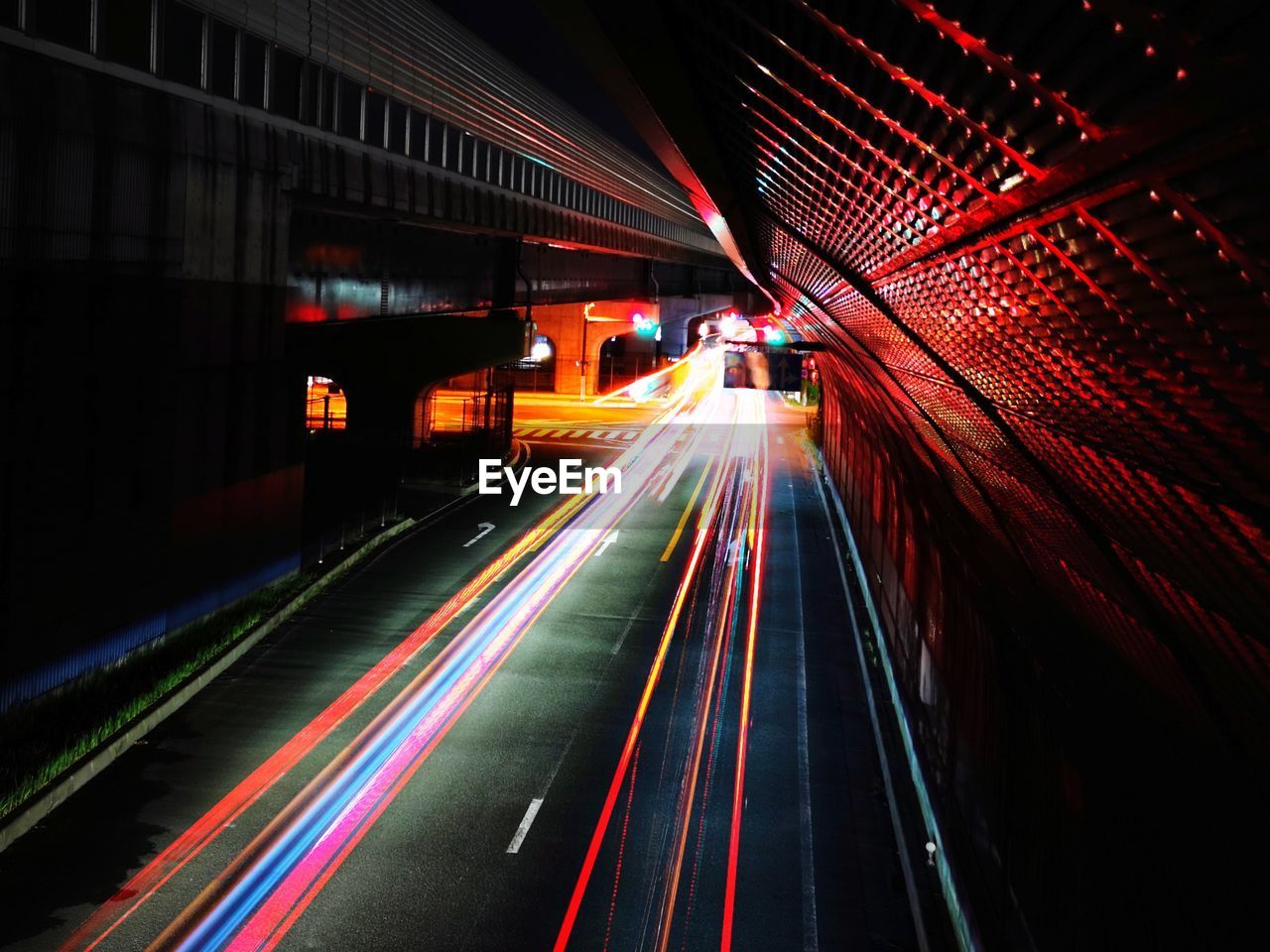 LIGHT TRAILS ON BRIDGE IN CITY