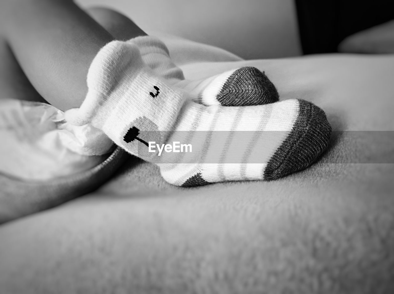Close-up of child resting on bed