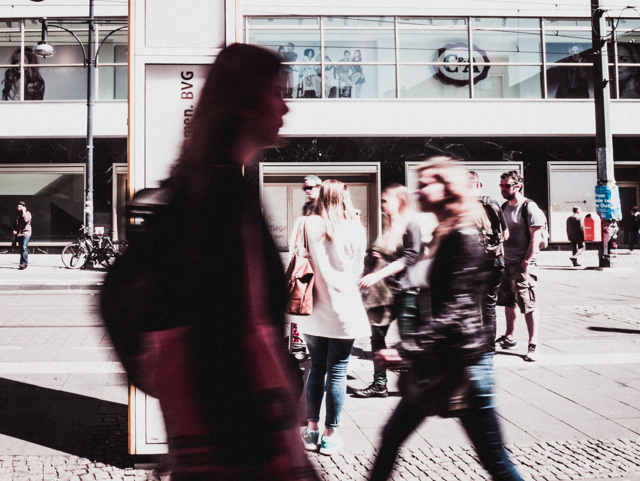 WOMAN STANDING ON CITY STREET