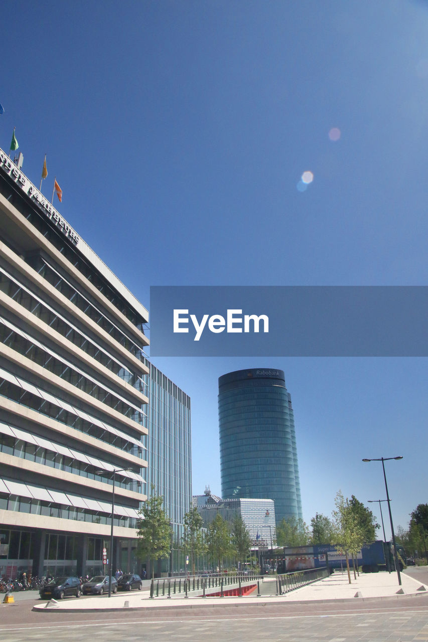 BUILDINGS AGAINST CLEAR BLUE SKY