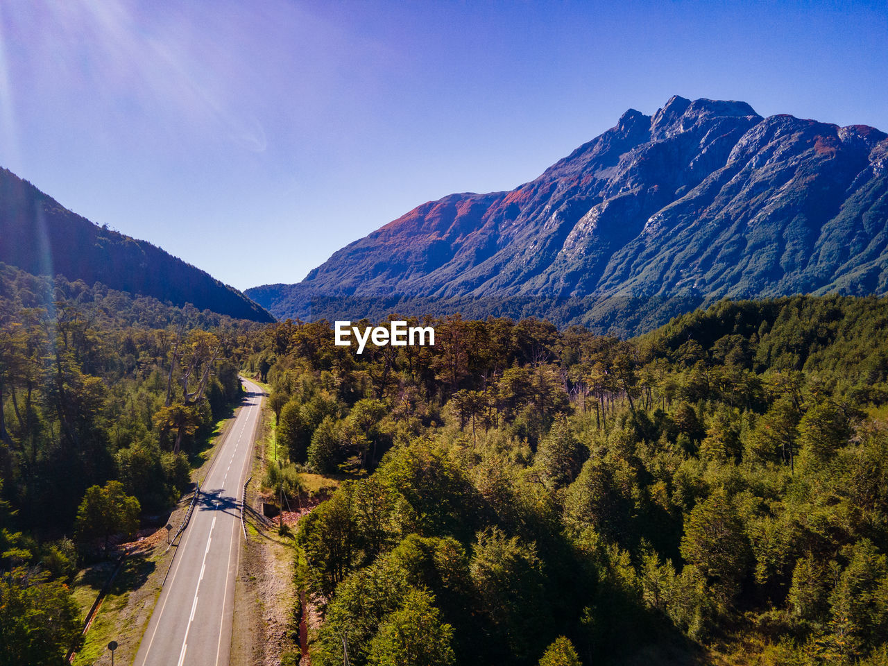 high angle view of road by mountains against sky