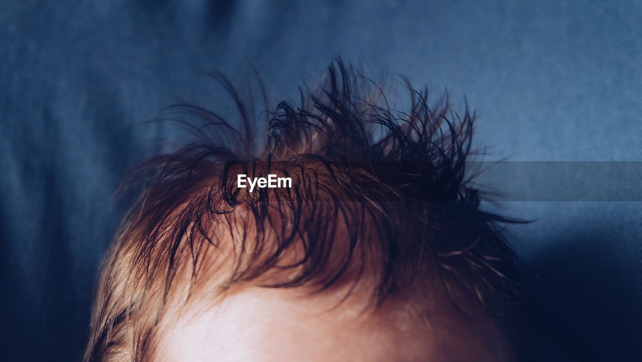 Cropped image of boy hair at home