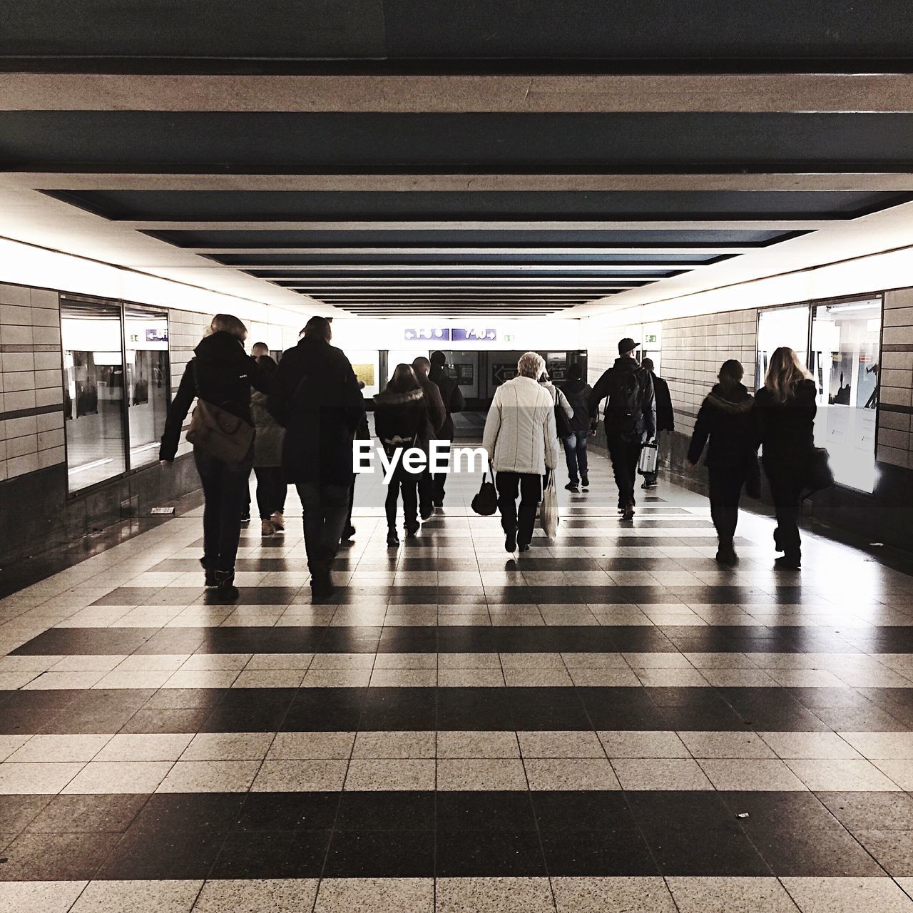 Group of people walking in subway