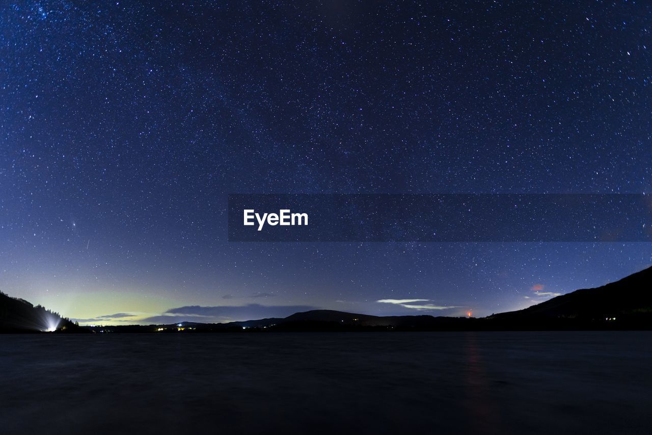 A night time view overlooking bassenthwaite lake in the english lake district with a faint aurora 