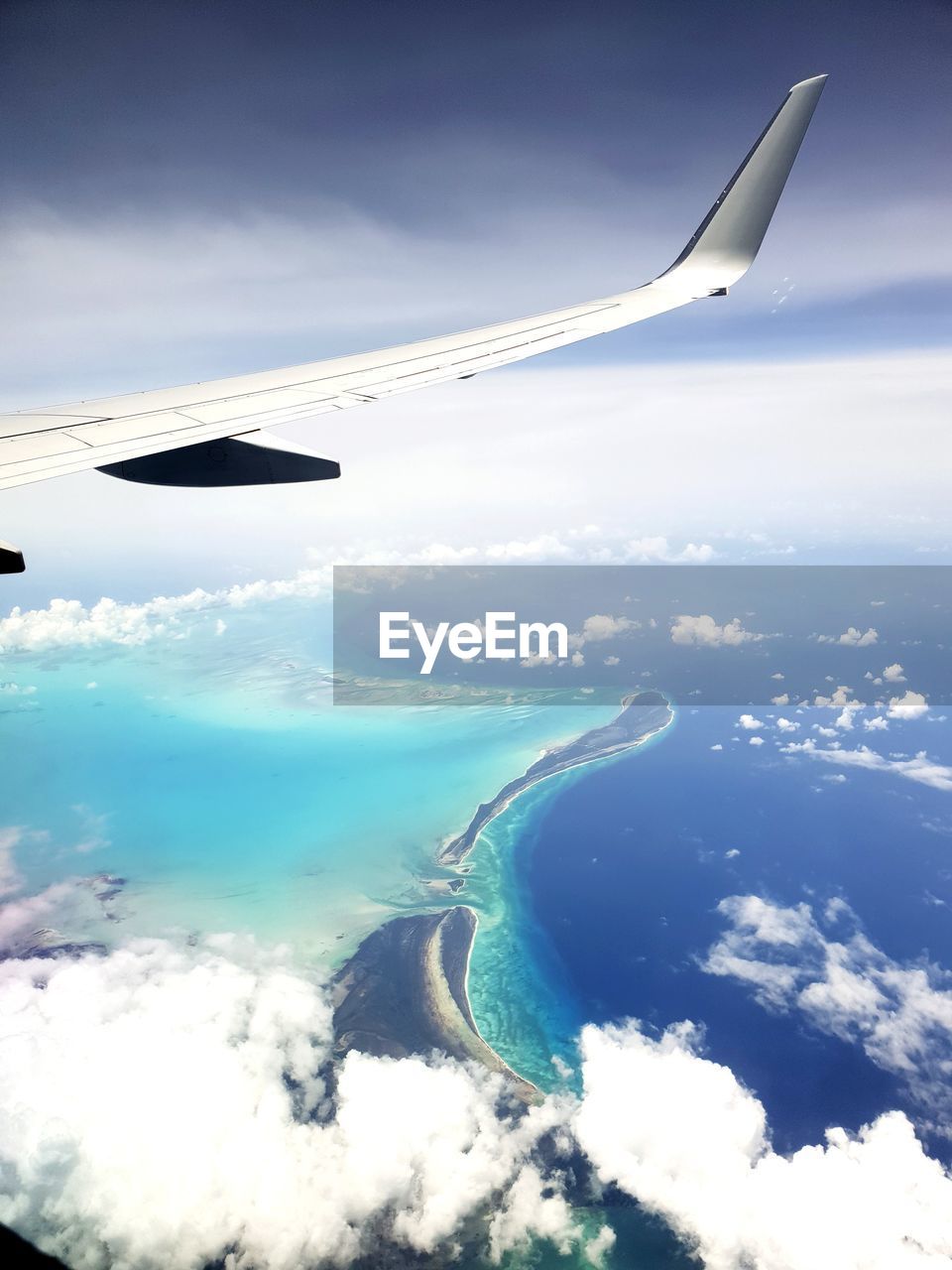 AERIAL VIEW OF SEA AND AIRPLANE FLYING IN SKY