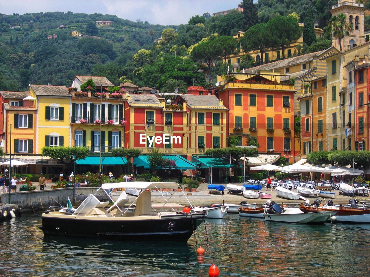 Sailboats moored on canal by buildings in city