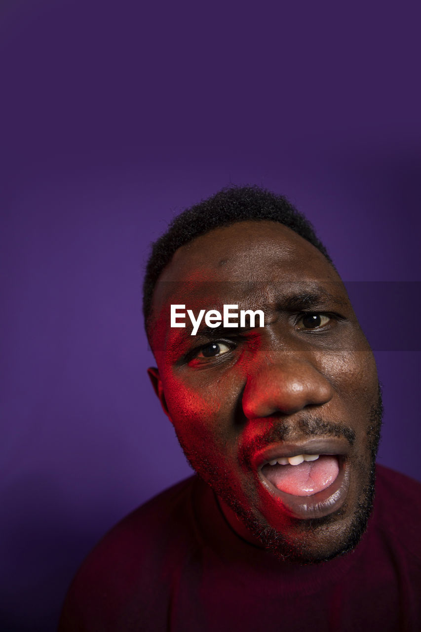 Portrait of smiling man against blue background