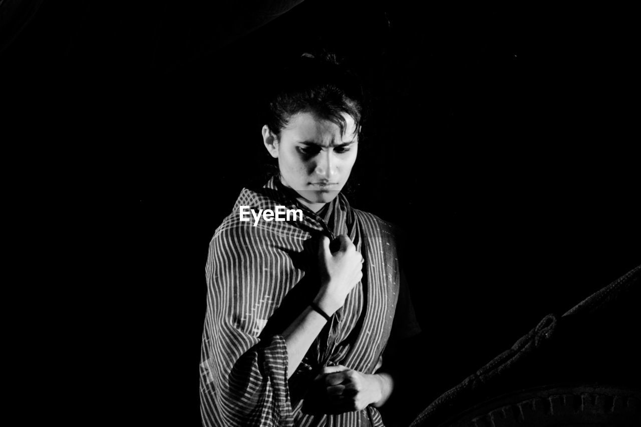 one person, black, black and white, musician, monochrome photography, young adult, adult, concert, arts culture and entertainment, waist up, indoors, portrait, monochrome, studio shot, darkness, music, black background, copy space, front view, standing, singing, musical instrument, looking at camera, performance, men, lifestyles, clothing