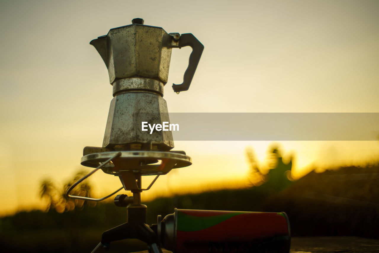 Antique coffee pot on the gas stove for camping when the sun rises in the morning.
