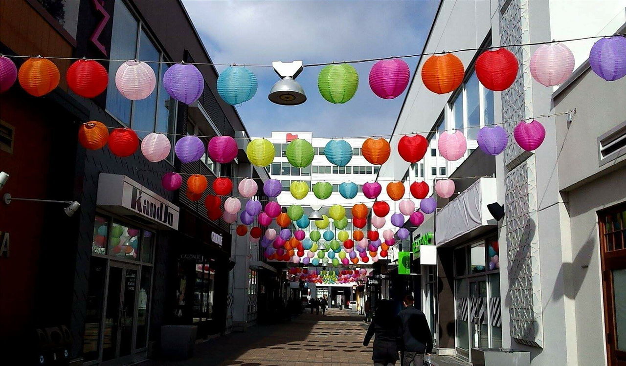 LOW ANGLE VIEW OF COLORFUL UMBRELLAS HANGING ON WALL