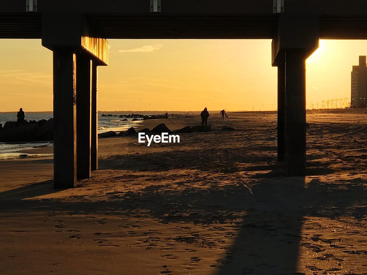 Scenic view of beach against sky during sunset