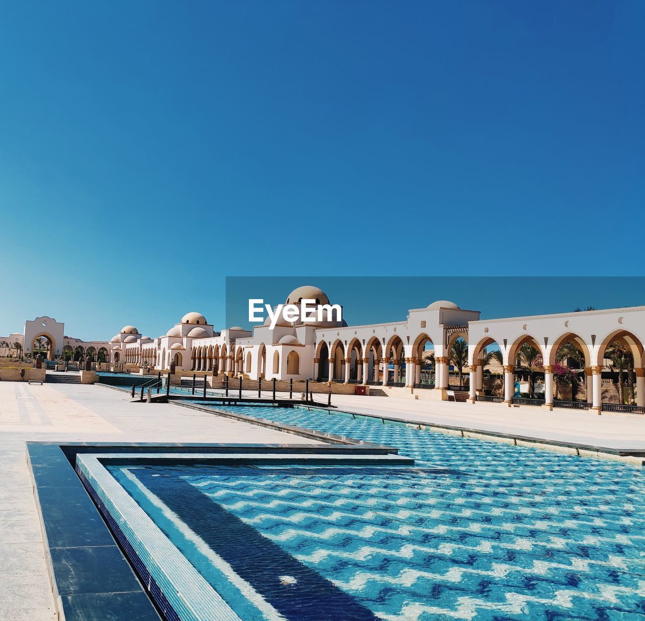 View of swimming pool against clear blue sky