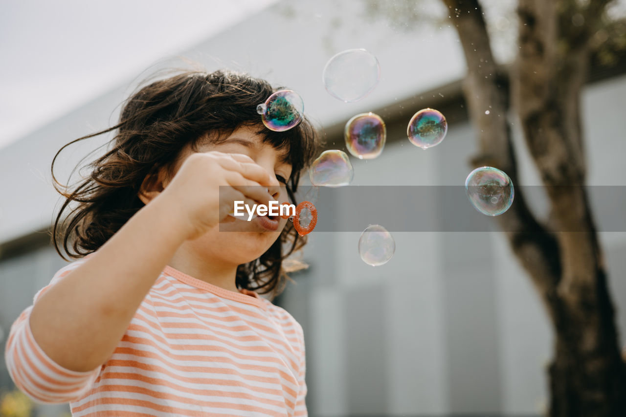 Child playing with soap bubbles