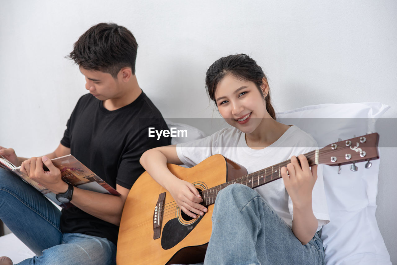 TWO MEN PLAYING GUITAR AT MUSIC CONCERT